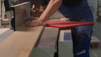 Industrial background with details of the workshop of the woodworking factory. Creative. Carpentry worker with a wooden board. video