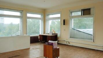 View inside of an empty old apartment with many big windows. Stock footage. Flat needs renovation. video