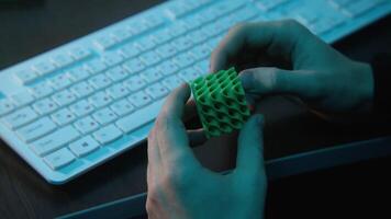 Man holding abstract cube in hands. Stock footage. Close-up of man holding puzzle cube. Man holds puzzle cube at office desk video