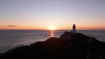 Lighthouse Perched on Rock by the Ocean video