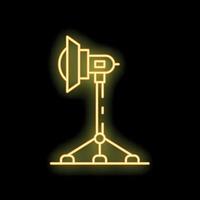 Neon yellow studio spotlight standing on tripod on black background vector
