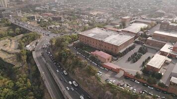 Yerevan, Armenia - 20th october, 2024- aerial top view Yerevan Ararat Brandy Factory buildings. Ararat museum. Vehicles in traffic on M5 highway video