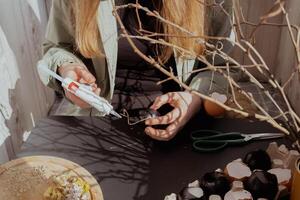 Tutorial How to make Easter table decoration with egg shells step by step instruction. Easter home decoration on wooden branch. Seasonal sustainable recycled decor photo