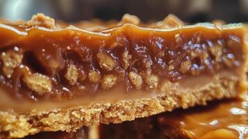 Delicious caramel slice showing crunchy biscuit base and gooey caramel topping photo