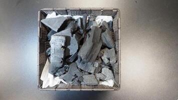 Natural wood charcoal traditional charcoal or hard wood charcoal on wooden table top view. photo