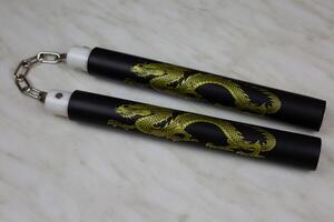 Training nunchucks made of soft material on white background, oriental inertial edged weapons of impact, shock-crushing and suffocating action, foam rubber training nunchucks photo