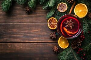 christmas mulled wine with oranges, cinnamon and spices on a wooden table photo