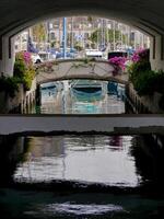 A view of the harbor pier through the arch in Puerto de Mogan, Gran Canaria photo