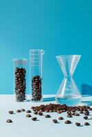 Coffee beans, grounds and water in laboratory glassware on a blue background. photo