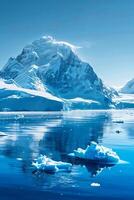 A serene, snow-capped mountain range reflects in the clear, icy water of the Antarctic. photo