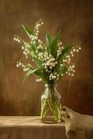A bouquet of lily of the valley flowers in a clear glass vase on a rustic wooden table. photo