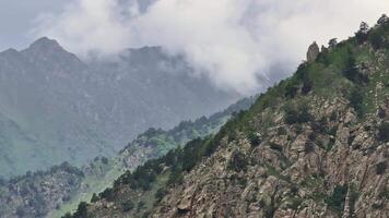 Majestic clouds drifting gracefully over a towering mountain peak video
