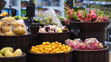 A close-up of exotic fruits displayed on supermarket shelves, showcasing vibrant colors and unique textures. This scene highlights the appeal of healthy, adventurous eating and culinary exploration video