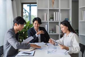 Diverse Team of Business Professionals Collaborating in Modern Office Setting for Idea Exchange and Project Planning photo