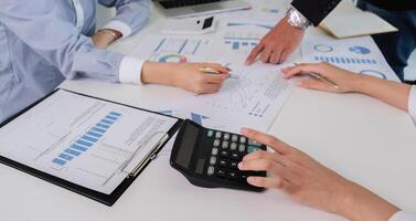 Team of Accountant Collaborating on Financial Calculation and Data Analysis in a Modern Office Setting photo