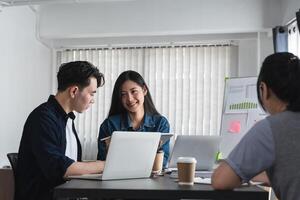 Team of Business Professionals Engaging in a Productive Discussion and Sharing Ideas in a Modern Office Setting photo