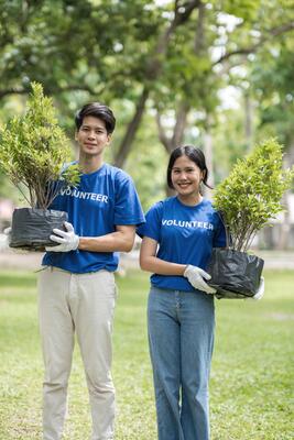 Volunteer Team Planting Trees in a Park to Promote Environmental Conservation and Community Engagement