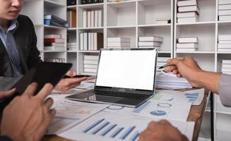 Business Team Collaborating on Project with Laptops with white screen and Documents in Modern Office Environment photo