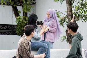 Students Gather in Groups to Study for Exams Outdoors in a Modern Campus Setting photo