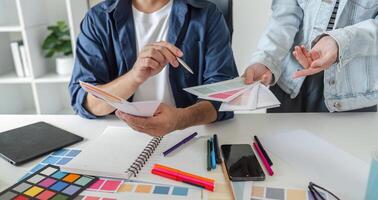 Graphic Designer Selecting Color Pairs on Computer for Creative Design Projects in Modern Workspace photo