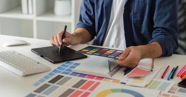 Graphic Designer Selecting Color Pairs on Computer for Creative Projects in Modern Workspace with Digital Tools and Color Swatches photo