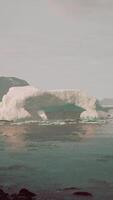 gigantic Ice block structures on the black sand by the sea shore video