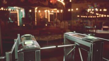 Empty amusement park entrance with illuminated carousel at night video