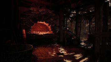 Dim workshop with a rustic oven and scattered tools in the mountains video