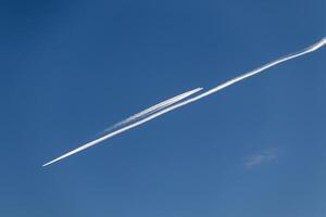 Contrails - two planes flying in opposite directions with condensation trails photo