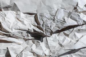 A textured background of crumpled white paper symbolizing chaos and creativity, perfect for concepts of recycling or brainstorming photo