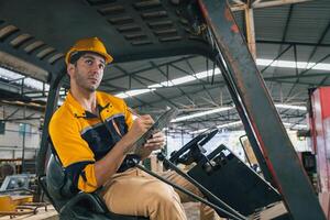 Caucasian engineer using a laptop in a factory. man working in plastics factory. photo