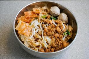 chicken noodle with meat balls and vegetables photo