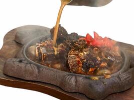 grilled ribs on hot plate isolated white background photo