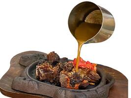 grilled ribs on hot plate isolated white background photo