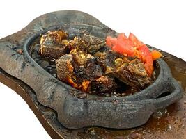 grilled ribs on hot plate isolated white background photo