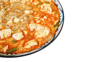 Spicy Kway Teow Soup with Tofu isolated on white background photo