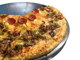pizza with toppings on a pan photo