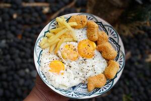 sunny side up egg with nuggets and french fries,breakfast. photo