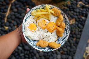 sunny side up egg with nuggets and french fries,breakfast. photo