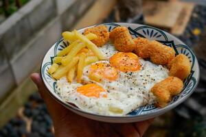 sunny side up egg with nuggets and french fries,breakfast. photo