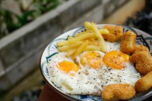 sunny side up egg with nuggets and french fries,breakfast. photo