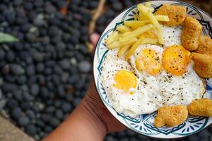sunny side up egg with nuggets and french fries,breakfast. photo