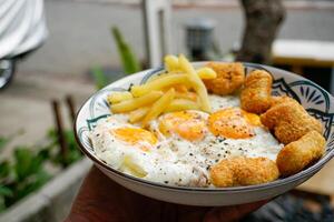 sunny side up egg with nuggets and french fries,breakfast. photo