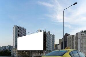 Large empty billboard ads along city highways on the background of a blue sky with beautiful clouds can be used for product display. Outdoor advertising posters for city streets photo