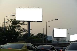 Blank template for outdoor advertising or blank billboard on highway at dusk with clipping path on screen - can be used for trade shows photo