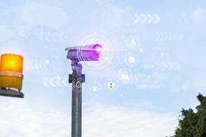 CCTV recording important events and a guard house and property. Modern CCTV camera on foggy day wall in city background with abstract infographics and HUD. photo