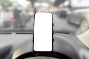 Modern smart phone gadgets. Install on car dashboard phone holder white screen mockup isolated template empty space for driver room view photo