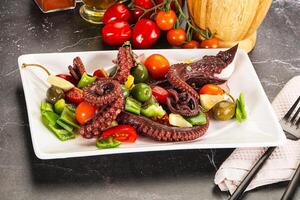 Salad with octopus tentacle and vegetables photo