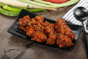 Manchurian chicken with sauce and spices photo
