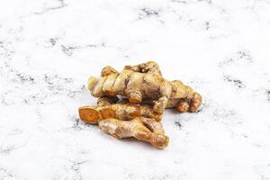 Fresh young Tumeric root heap photo